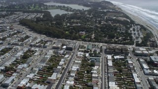 AX0175_0186 - 6K aerial stock footage of flying over Outer Sunset District homes, tilt to shops, San Francisco, California