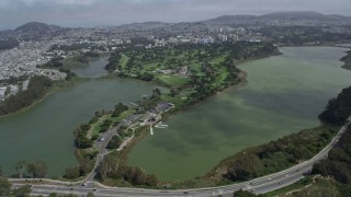 AX0175_0188 - 6K aerial stock footage of a golf course and Lake Merced in Lakeshore, San Francisco, California