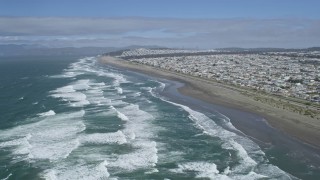 AX0175_0189 - 6K stock footage aerial video of waves rolling toward Ocean Beach and the Outer Sunset District, San Francisco, California