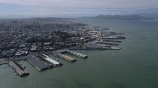 AX0175_0202 - 6K aerial stock footage of Coit Tower and North Beach piers, San Francisco, California