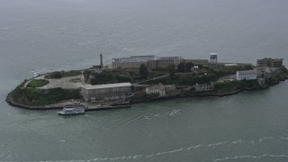 AX0175_0204 - 6K aerial stock footage orbit Alcatraz as a ferry sails by, San Francisco Bay, California