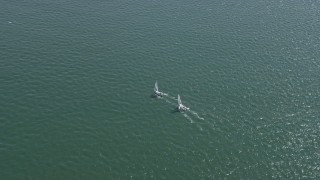 AX0175_0210 - 6K aerial stock footage of tracking sailboats on San Francisco Bay, California
