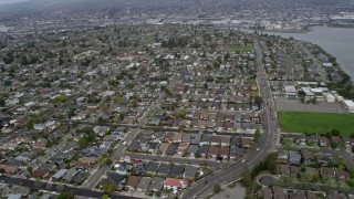 AX0175_0220 - 6K aerial stock footage of flying past suburban neighborhoods in Alameda, California