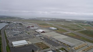 AX0175_0221 - 6K aerial stock footage of flying past runways at Oakland Airport, California