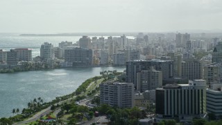 AX101_003 - 4.8K aerial stock footage of Waterfront Apartment Buildings, San Juan Puerto Rico Raining