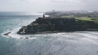 AX101_015 - 4.8K aerial stock footage of a historic fort along the coast with clear blue water, Old San Juan Puerto Rico