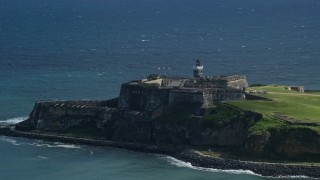 AX101_018E - 4.8K aerial stock footage of a Historic fort along the coast in the blue waters of the Caribbean, Old San Juan Puerto Rico
