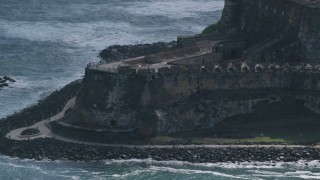 AX101_022 - 4.8K aerial stock footage of a Historic fort and lighthouse on the coast, Old San Juan Puerto Rico