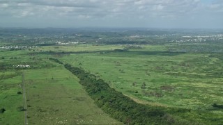 AX101_030 - 4.8K aerial stock footage Flying over grassland, Toa Baja, Puerto Rico