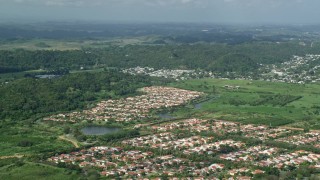 AX101_033E - 4.8K aerial stock footage of Residential neighborhoods among trees and grassy areas, Dorado, Puerto Rico
