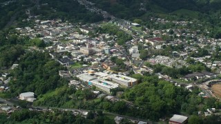 AX101_046E - 4.8K aerial stock footage of a Town surrounded by trees, Ciales, Puerto Rico