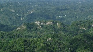AX101_069 - 4.8K aerial stock footage of Limestone cliffs and lush green forests, Karst Forest, Puerto Rico