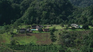 AX101_071 - 4.8K aerial stock footage of an Isolated farmhouse among lush green forests, Karst Forest, Puerto Rico