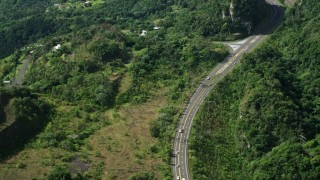 AX101_073 - 4.8K aerial stock footage of a Highway winding through lush green forests, Karst Forest, Puerto Rico