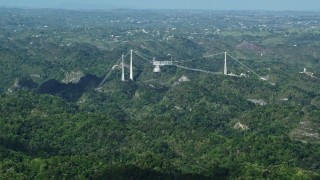 AX101_087 - 4.8K aerial stock footage of Arecibo Observatory nestled among the lush green Karst Forest, Puerto Rico