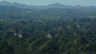 AX101_088E - 4.8K aerial stock footage of Limestone cliffs among lush green Karst Forest, Puerto Rico
