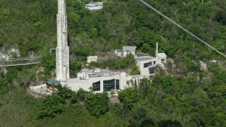 AX101_102 - 4.8K aerial stock footage of Arecibo Observatory building set among trees, Puerto Rico