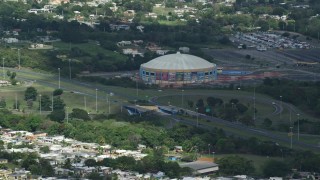 AX101_132E - 4.8K aerial stock footage of the Coliseo Manuel Iguina sporting arena, Arecibo Puerto Rico