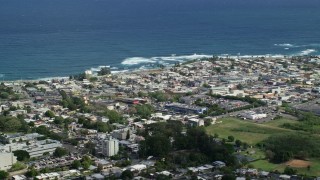 AX101_136 - 4.8K aerial stock footage of a Coastal community homes and apartment buildings, Arecibo, Puerto Rico 