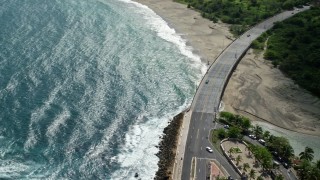 AX101_139E - 4.8K aerial stock footage of the coastal highway, Avenida Victor Rojas, Arecibo, Puerto Rico