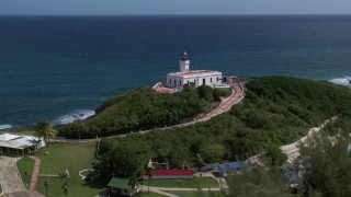 AX101_144 - 4.8K aerial stock footage of the Arecibo Lighthouse along the coastal waters of the Caribbean, Puerto Rico 