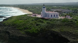AX101_148E - 4.8K aerial stock footage orbiting and then approaching the Arecibo Lighthouse along the coast, Puerto Rico