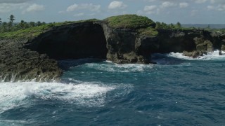 AX101_162 - 4.8K aerial stock footage of Rock formations along the coast of clear blue water, Arecibo, Puerto Rico 