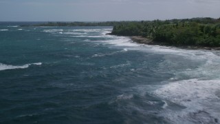 AX101_179 - 4.8K aerial stock footage of Crystal blue waters along the beach, Barceloneta, Puerto Rico 