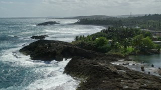 AX101_180E - 4.8K aerial stock footage of crystal blue waters and oceanfront property, Barceloneta, Puerto Rico