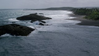 AX101_182 - 4.8K aerial stock footage of Rock formation in clear waters along the coast, Barceloneta, Puerto Rico 