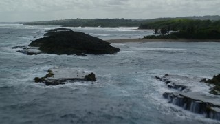 AX101_186 - 4.8K aerial stock footage Flying over clear waters and beach along the coast, Manati, Puerto Rico