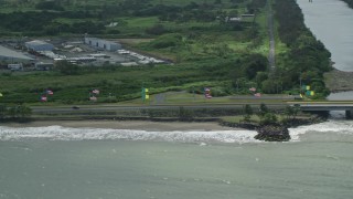AX101_231 - 4.8K aerial stock footage of Flags displayed along Highway 165, Toa Baja, Puerto Rico
