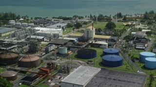 AX101_232E - 4.8K aerial stock footage of a Bacardi Rum Factory along crystal blue waters, Cataño Puerto Rico