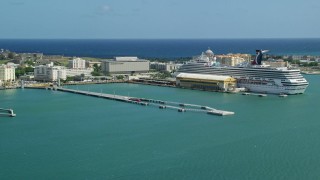 AX101_237 - 4.8K aerial stock footage of a Cruise ship in crystal blue waters, Port of San Juan, Puerto Rico 