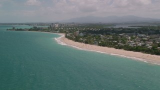 AX102_005 - 4.8K aerial stock footage of Beaches and coastal community along crystal blue water, San Juan, Puerto Rico 