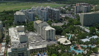 AX102_010 - 4.8K aerial stock footage of El San Juan Resort and Casino and apartment buildings, Carolina, Puerto Rico 