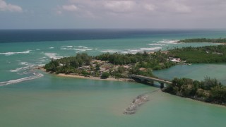 AX102_015 - 4.8K aerial stock footage of Coastal shops and beach along crystal turquoise waters, Loiza, Puerto Rico