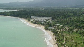 AX102_038 - 4.8K aerial stock footage of Turquoise waters and beachside condominiums, Rio Grande, Puerto Rico