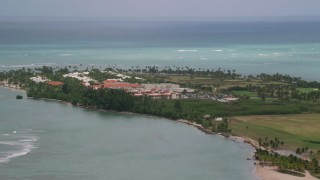 AX102_041 - 4.8K aerial stock footage of a Golf resort along clear turquoise waters, Gran Melia Golf Resort, Puerto Rico