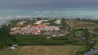 AX102_042 - 4.8K aerial stock footage of golf resort by clear turquoise waters, Gran Melia Golf Resort, Puerto Rico