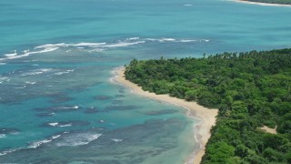 AX102_054 - 4.8K aerial stock footage of Reefs among crystal blue waters along the beach, Luquillo, Puerto Rico 