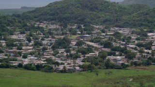 AX102_055 - 4.8K aerial stock footage of Homes among tree covered hills, Fajardo, Puerto Rico 