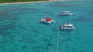 AX102_078E - 4.8K aerial stock footage of catamarans in tropical blue waters, Rada Fajardo, Puerto Rico