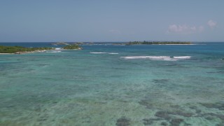 AX102_082 - 4.8K stock footage aerial video Flying low over crystal blue waters, Puerto Rico 