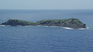 AX102_104 - 4.8K aerial stock footage of a Small rocky green island in sapphire blue waters, Culebra, Puerto Rico 