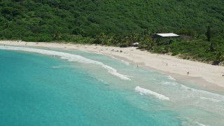 AX102_113 - 4.8K aerial stock footage of Sapphire blue waters and beachgoers on white sand Caribbean Flamenco Beach, Culebra, Puerto Rico 