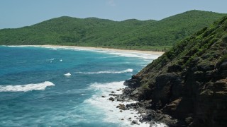 AX102_115E - 4.8K aerial stock footage fly over sapphire blue waters, reveal a Caribbean beach and lush vegetation, Culebra, Puerto Rico