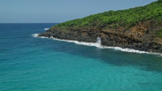 AX102_119 - 4.8K aerial stock footage of Sapphire blue waters against a rocky coast, Culebra, Puerto Rico