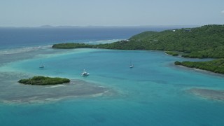 AX102_136 - 4.8K aerial stock footage of a Fishing boat and sailboats in turquoise blue waters along the coast, Culebra, Puerto Rico 