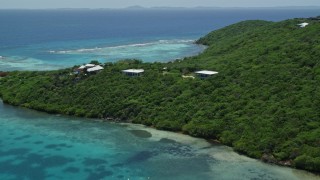 AX102_137 - 4.8K aerial stock footage of Oceanfront homes nestled among trees along sapphire blue waters, Culebra, Puerto Rico 